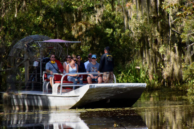 people on an airboat in the louisiana swamp